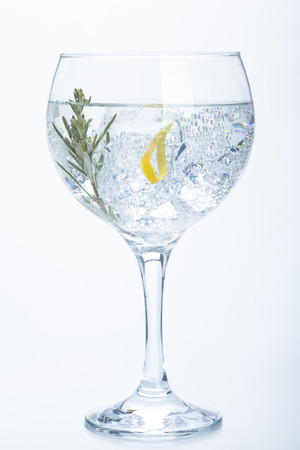 rosemary and lemon gin tonic isolated over white の写真素材