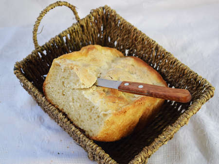 homemade bread on a tray with a knife