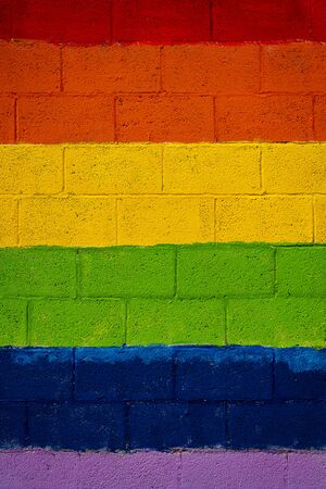 Vertical color image with a front view of a wall with the colors of the LGBT flagの写真素材