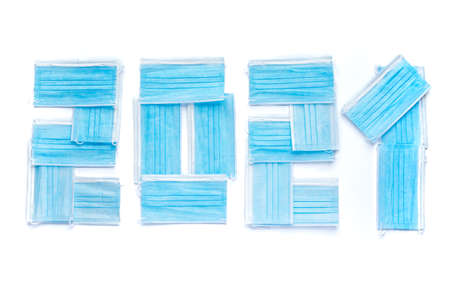A numbers of the year 2021 made with blue face masks on  white