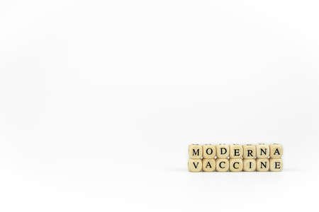 Horizontal color image with a front view of the name of pharmaceutical company written with wooden letters on a white background. Race to find the vaccine against the Coronavirus pandemic. Covid concept.の写真素材