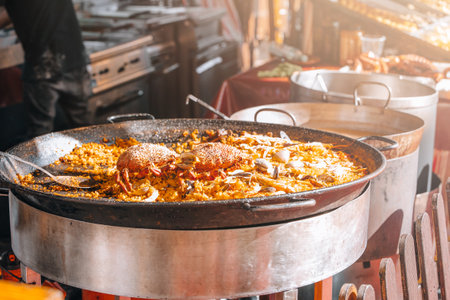 Street food market, paella in medieval fair. rice with seafood in street marketの写真素材