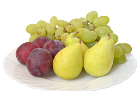 plate with plums, grapes and pears isolated on white backgroundの写真素材
