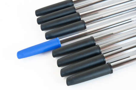 group of black pens with a blue one isolated on white background with clipping pathの写真素材