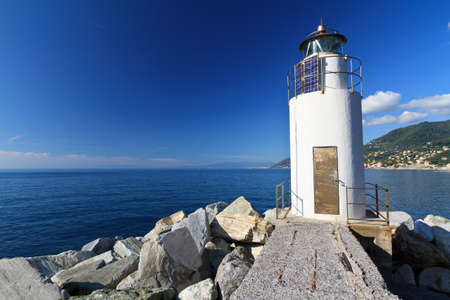 lighthouse over Mediterranean sea in Camogli, Italyの写真素材