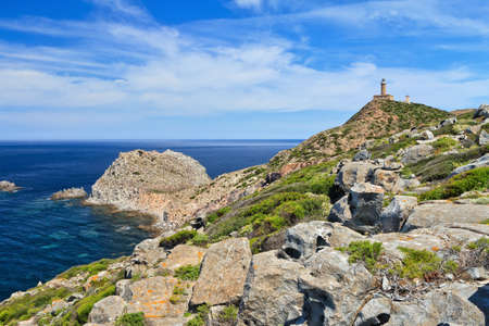 cliff and lighthouse in Capo Sandalo, Carloforte, Sardinia, Italyの写真素材
