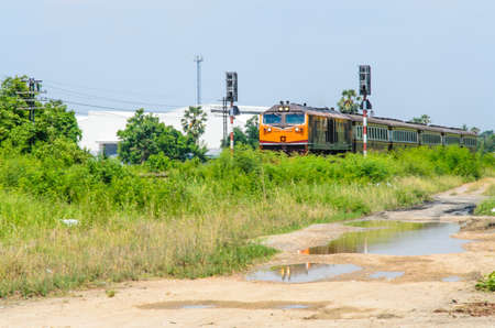 Diesel train is traveling in the suburbs of Thailand.の写真素材