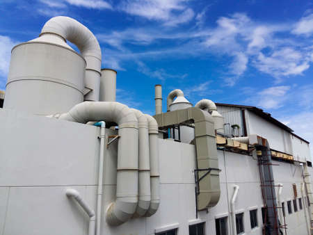 Industrial plant for filtering air polluted ponds with tanks, and water tanks on blue sky...