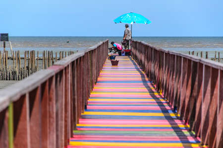 Two men are painting wooden bridges on the beach / colorful beautiful.のeditorial素材