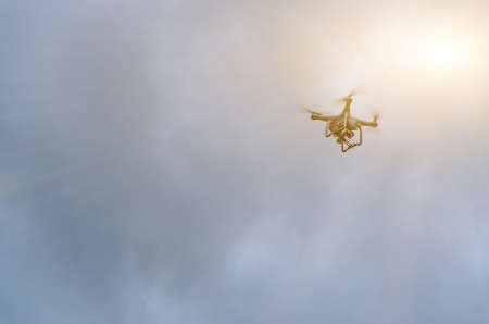 Drone flying on the cloudy sky and sunlight.の写真素材