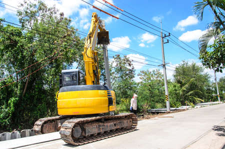 Yellow digger on construction site.