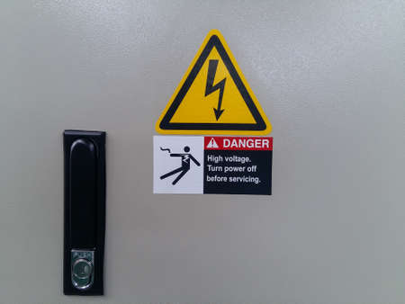 Warning sign of high voltage at the control box door.