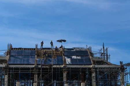 under construction worker on construction site on blue sky backgroundの写真素材