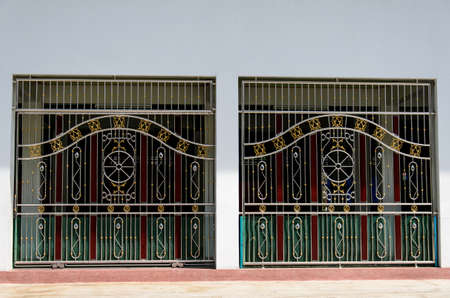House fence made of stainless steel and brown wood sheet,Stainless steel door and fence on the wall,House fence made of stainless steelの写真素材