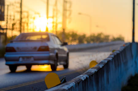 Blurry the car on the street at sunset background, blurred image