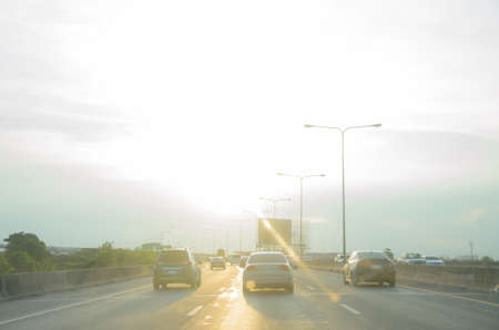 Car running on the freeway with a sunrise background.の写真素材