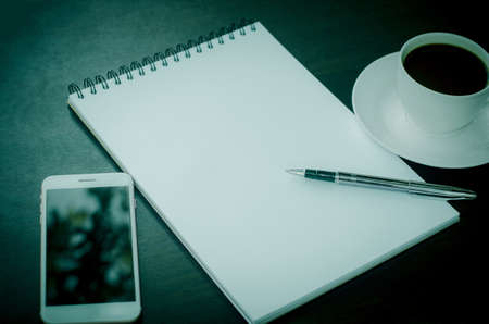 Blank books, coffee cups, pens and mobile phone  for design ideas.の写真素材
