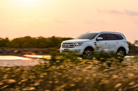 Samut Sakhon, Thailand - March 2019: Ford Everest Titanium, Motion image, car running on the road with the sunset background, at Samut Sakhon Province on 3 March 2019 in Samut Sakhon, Thailand.のeditorial素材