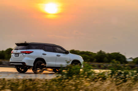 Samut Sakhon, Thailand - March 2019: TOYOTA Fortuner, Motion image, car running on the road with the sunset background, at Samut Sakhon 3 March 2019 in Samut Sakhon, Thailand.のeditorial素材