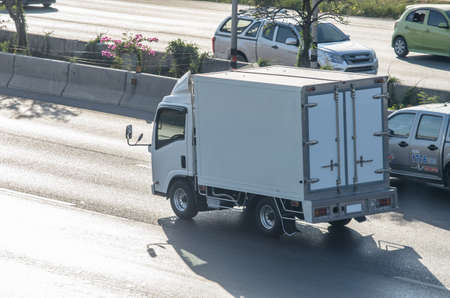 Samut Sakhon, Thailand - May 2019: Small white trucks running on Rama 2 Road on 1 May 2019 in Samut Sakhon Province, Thailand.のeditorial素材