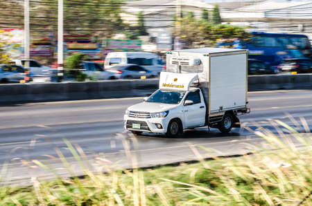 Samut Sakhon, Thailand - April 2019: A small white truck running on Rama II Road on April 16, 2019 in Samut Sakhon, Thailand.のeditorial素材