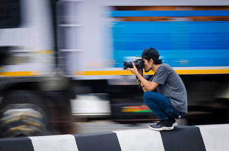 Samut Sakhon, Thailand - June 2019: Street photographers are taking pictures of running cars on on Rama 2 Road on June 2, 2019 at Samut Sakhon, Thailand.のeditorial素材