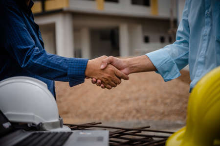 Shaking hands with engineers and architects agree with the success of the construction project.