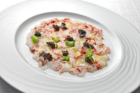 Fish Appetizer Carpaccio of Red Prawns and Caviar in white round plateの写真素材