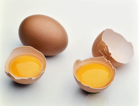Two whole Eggs and two broken eggs with Yolk