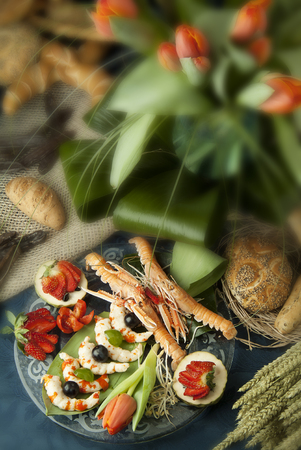 Seafood plate with fruit bread and flowersの写真素材