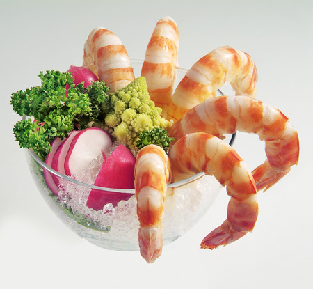Bowl with ice Prawns and Vegetables on White planeの写真素材