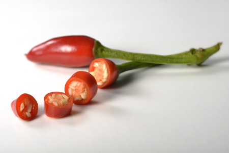 Whole hot pepper and one cutted on whiteの写真素材