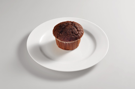 Round dish with chocolate muffins isolated on grey backgroundの写真素材