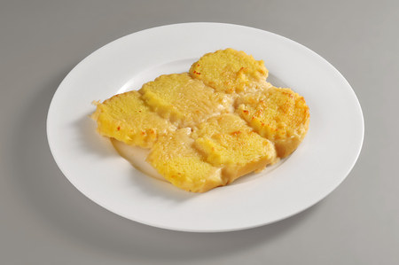 Round dish with a portion of semolina dumplings isolated on grey backgroundの写真素材