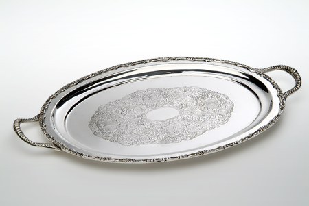 Engraved oval silver tray isolated on white backgroundの写真素材