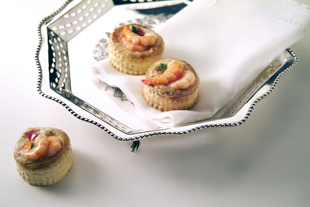 silver table basket with shrimp snacks and napkinの写真素材