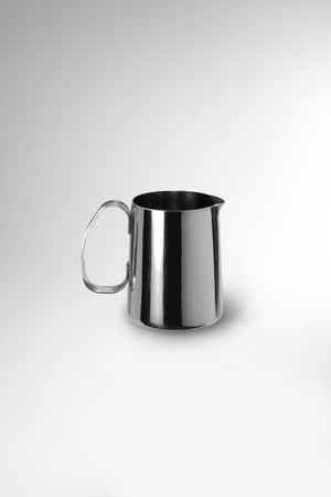 steel jug pots for milk isolated on whiteの写真素材