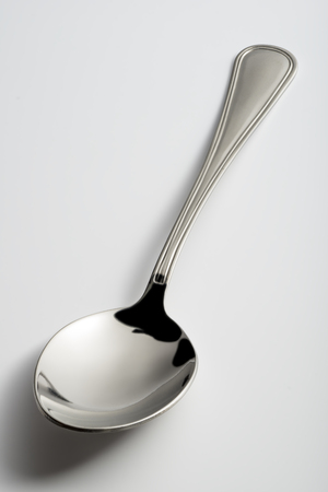 Empty steel Spoon isolated on white backgroundの写真素材