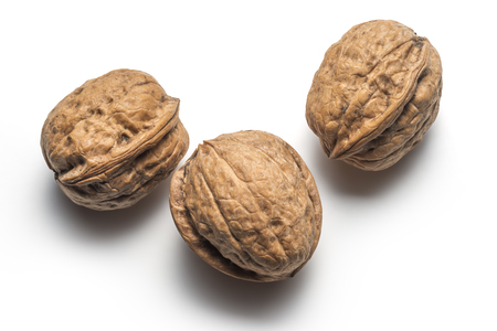 Three whole walnuts on white backgroundの写真素材