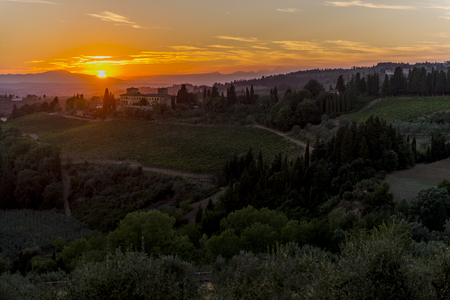 Warm Sunset over the hills of Siena in Tuscanyの写真素材