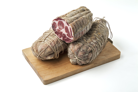 Cutting board with salami air-cured pork meat cup isolated on white backgroundの写真素材