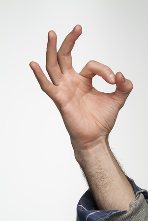 Ok hand sing gesture isolated on white backgroundの写真素材