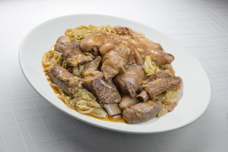 Plate with pork meat and savoy cabbage on whiteの写真素材
