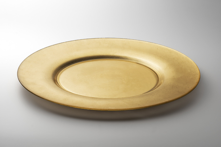 Empty Golden round flat plate isolated on white backgroundの写真素材