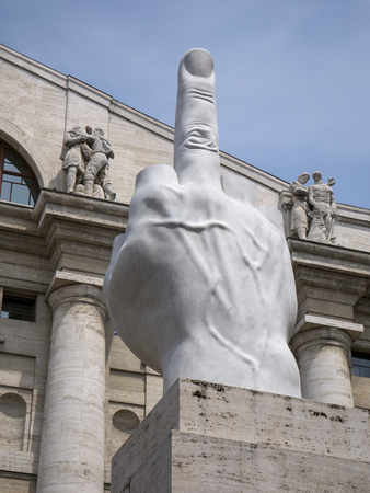 Milan, Italy - May 25, 2019: Middle finger sculpture and Mezzanotte Palace facade in Milan Stock Exchange, symbol and heart of Italian financeのeditorial素材