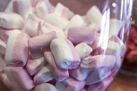 Detail of Glass jar with white and pink Marshmallowsの写真素材