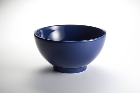 Empty blue bowl isolated on whiteの写真素材