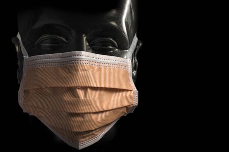Surgical protective orange Mask on Transparent Dummy isolated on black backgroundの写真素材