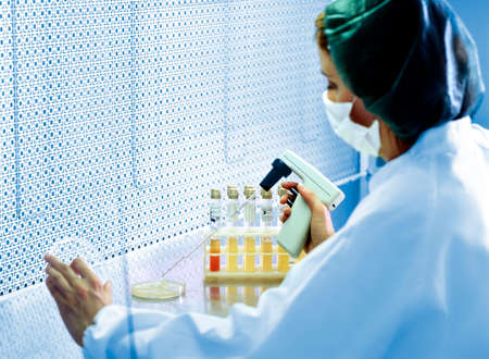 Milan, Italy - March 17, 2020: Woman doctor working with Pipe in Biological Laboratoryのeditorial素材