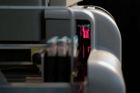 Milan, Italy - November 18, 2020: Detail of instrument in laboratory for medical analysis with rack of tubes bloodのeditorial素材